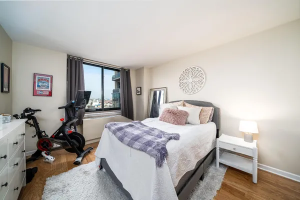 a bedroom with a bed and a dresser in it