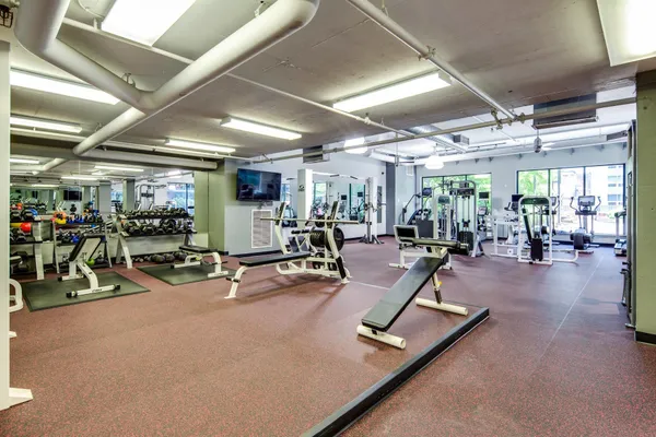 a living room with patio furniture and a chandelier