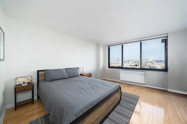 a bedroom with a bed and a window