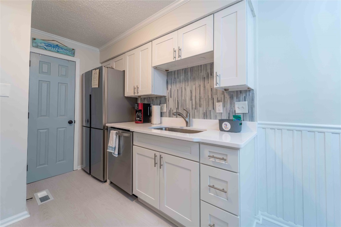 2562 Forest Ridge Drive, Unit P2 Fernandina Beach, FL 32034 - Photo 11 of 23 a kitchen with white cabinets and refrigerator