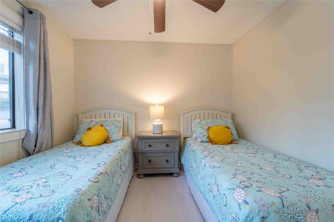 2562 Forest Ridge Drive, Unit P2 Fernandina Beach, FL 32034 - Photo 19 of 23 a bedroom with a bed and two large windows