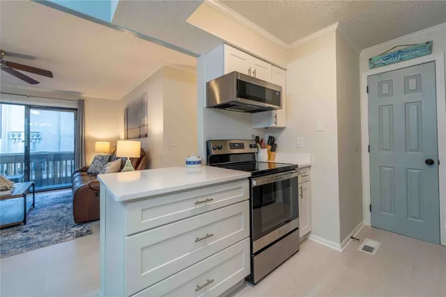 a kitchen with a sink and a stove top oven