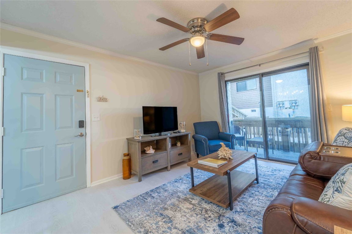 2562 Forest Ridge Drive, Unit P2 Fernandina Beach, FL 32034 - Photo 9 of 23 a living room with furniture a flat screen tv and a window