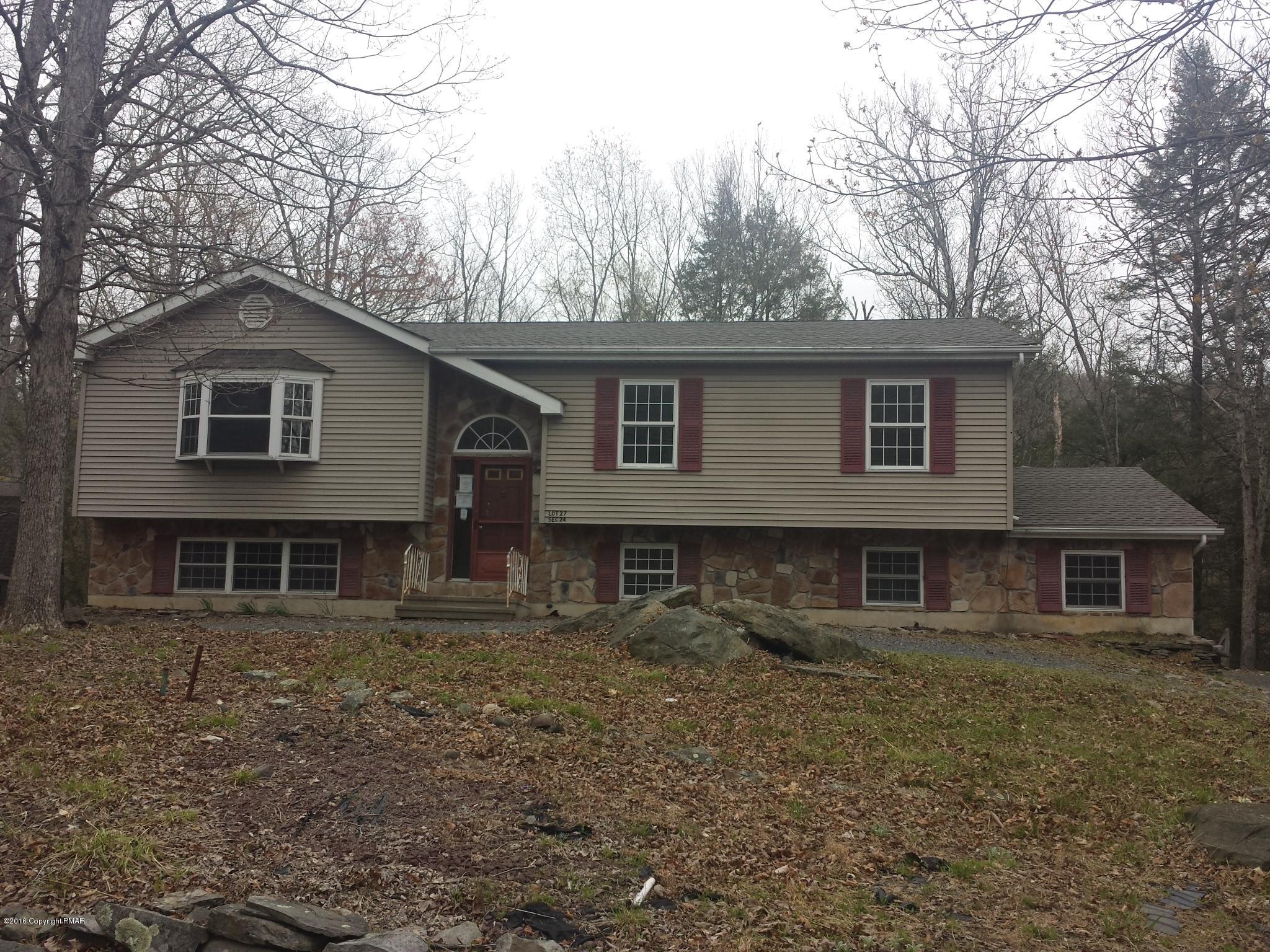 5766 Decker Road Bushkill, PA 18324 - Photo 1 of 13 a house that has a tree in front of it