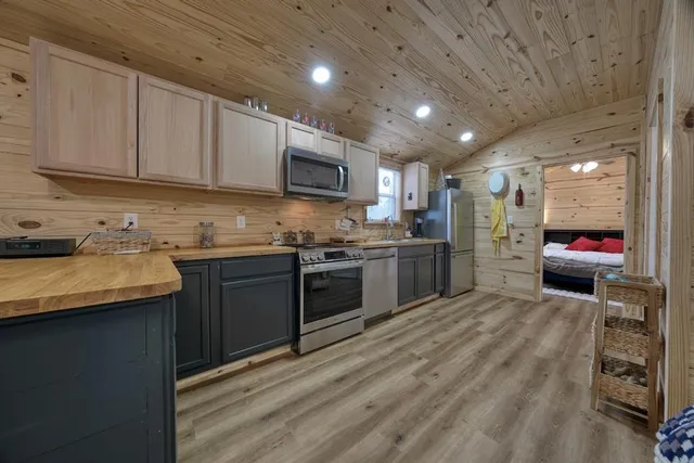 a kitchen with stainless steel appliances granite countertop a stove microwave and sink