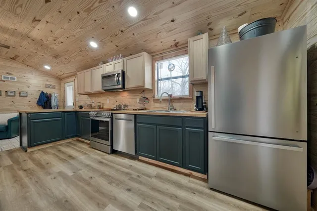 a sink with a faucet a sink and cabinets