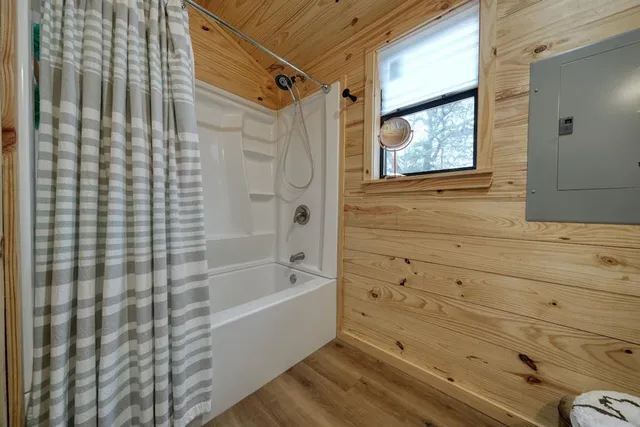 a spacious bedroom with a bed and a chandelier