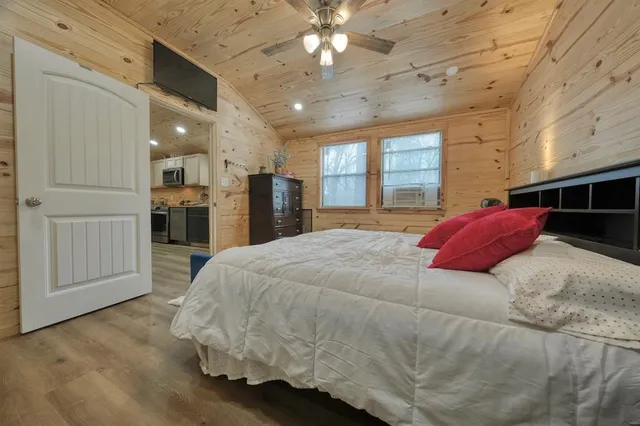 a spacious bedroom with a bed and a chandelier