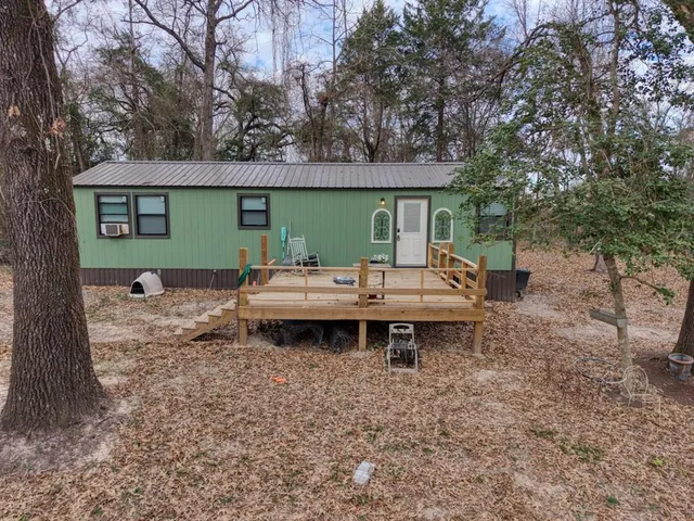 a backyard of a house with barbeque oven table and chairs