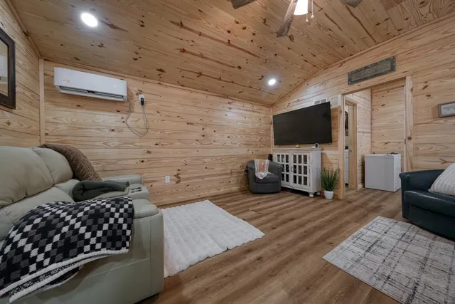 a living room with furniture and kitchen view