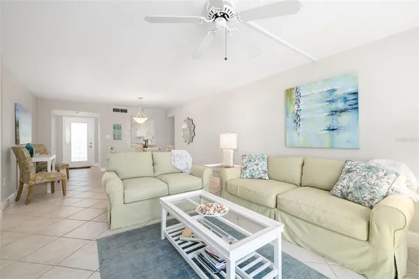 a living room with furniture a rug and a chandelier