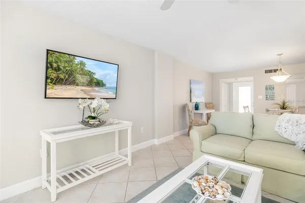 a living room with furniture and a painting on the wall