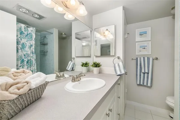 a en suite bathroom with a sink double vanity and a mirror