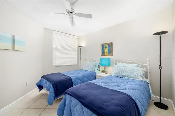a bedroom with two beds and painting on the wall