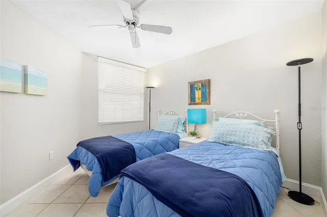 a bedroom with two beds and painting on the wall