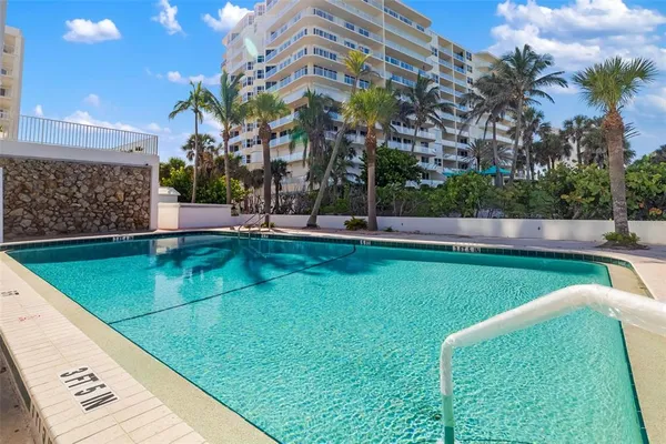 a view of a swimming pool with a yard