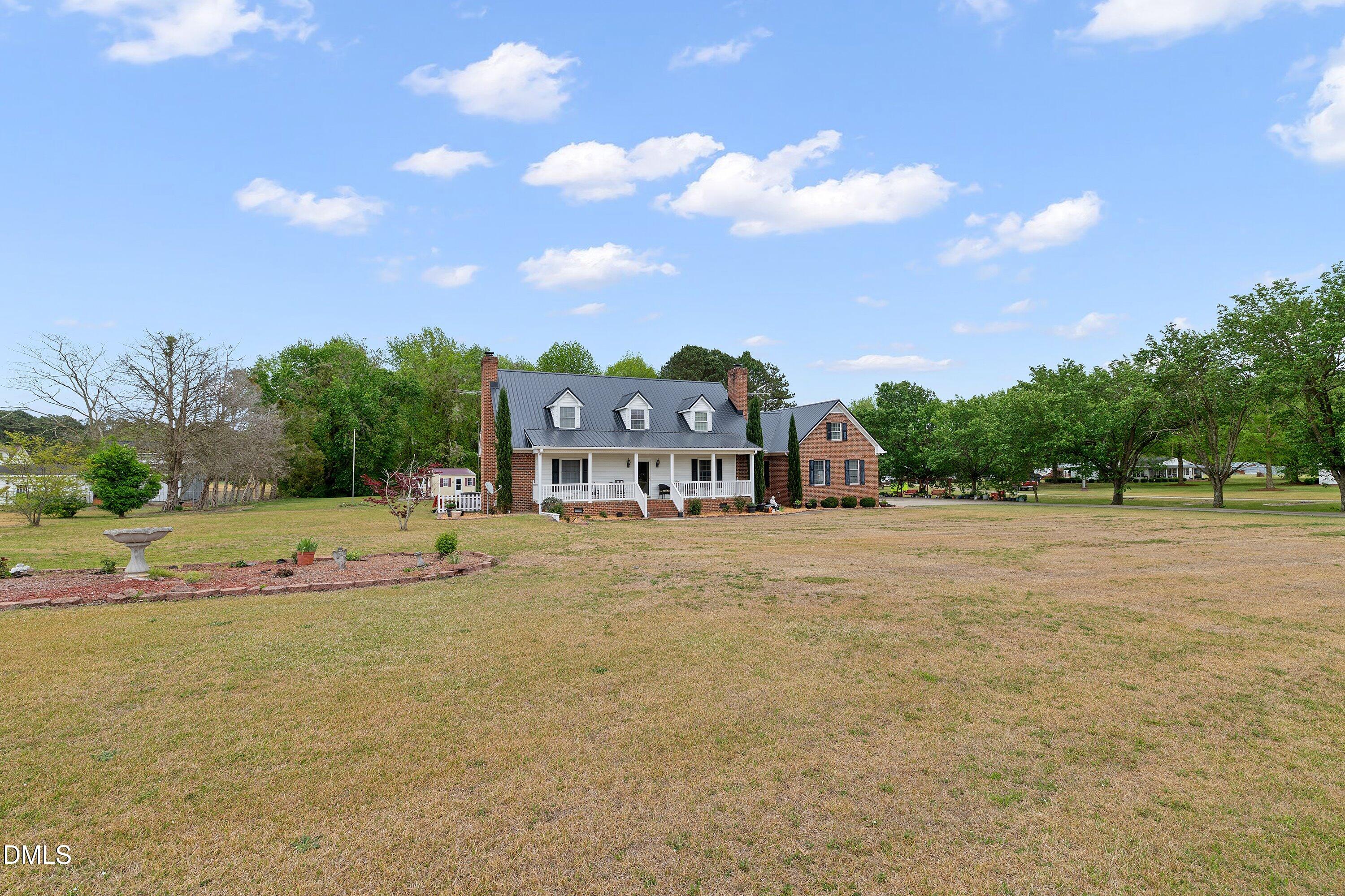 6314 Old Davis Road Sims, NC 27880 - Photo 3 of 71 a view of white house with a big yard and large trees