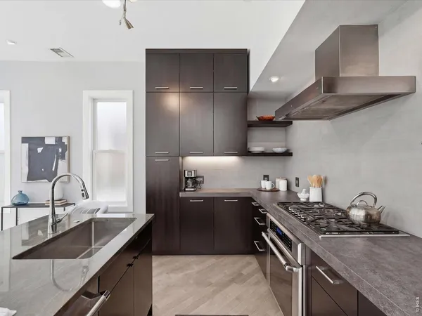 a kitchen with stainless steel appliances granite countertop a sink stove and refrigerator
