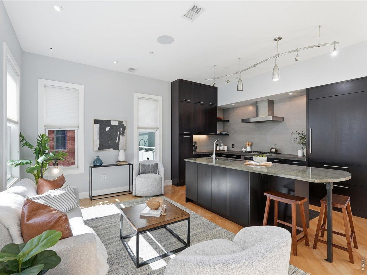 a kitchen with stainless steel appliances granite countertop a stove a sink a dining table and chairs