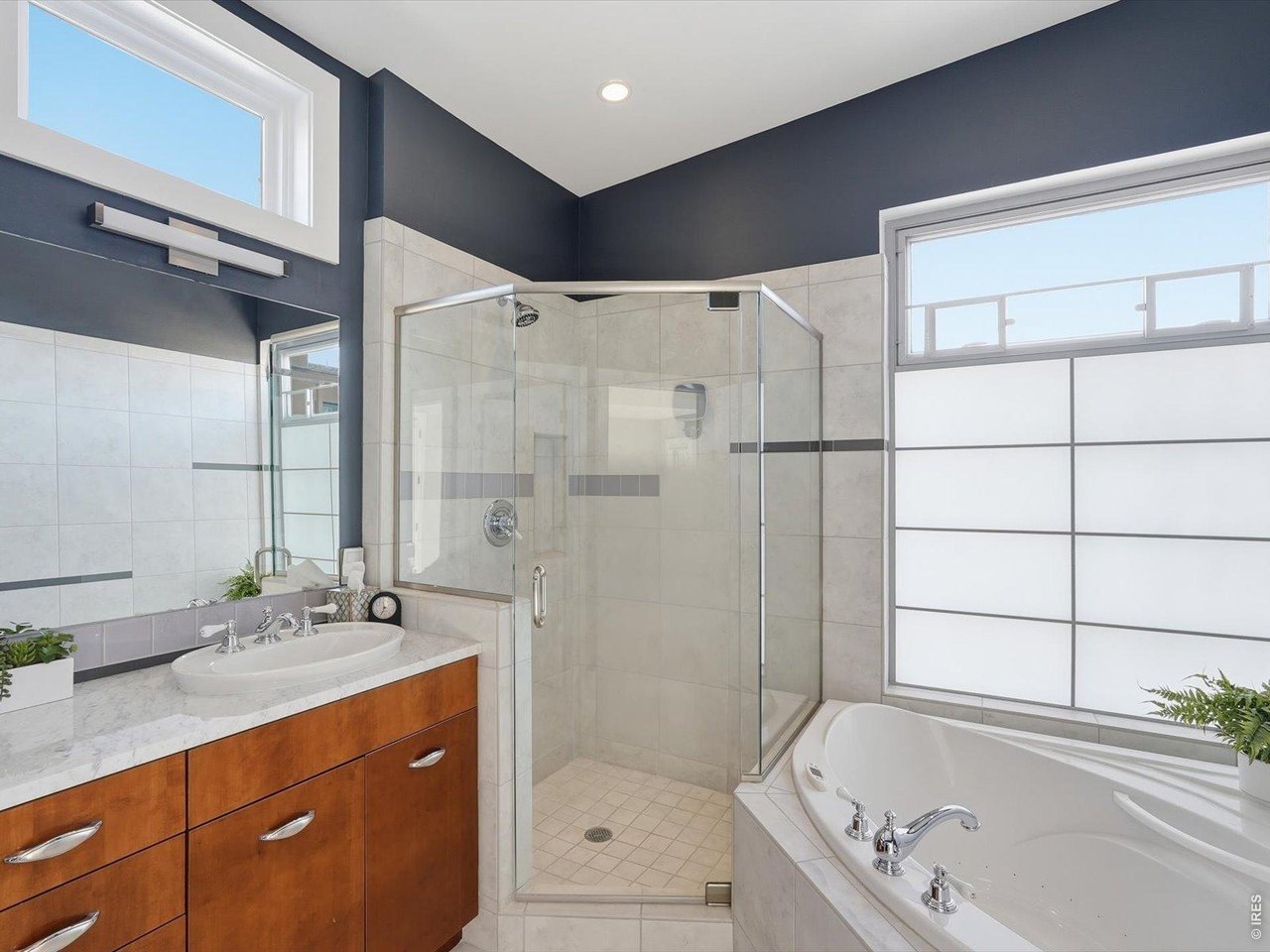 2336 Spruce Street, Unit E Boulder, CO 80302 - Photo 29 of 48 a bathroom with a granite countertop sink mirror bathtub and shower