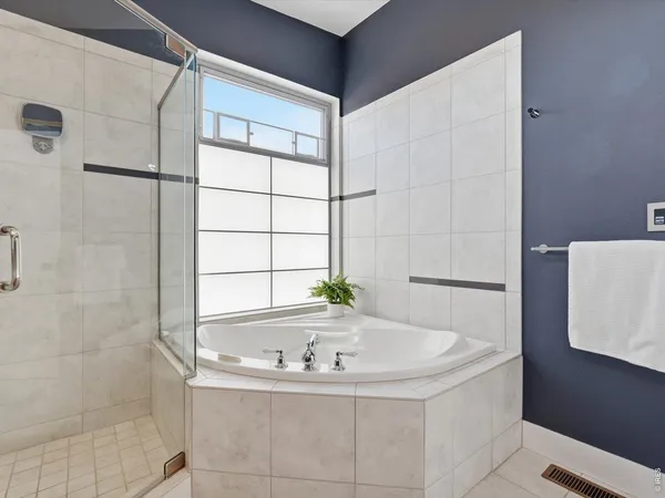 a bathroom with bathtub and window