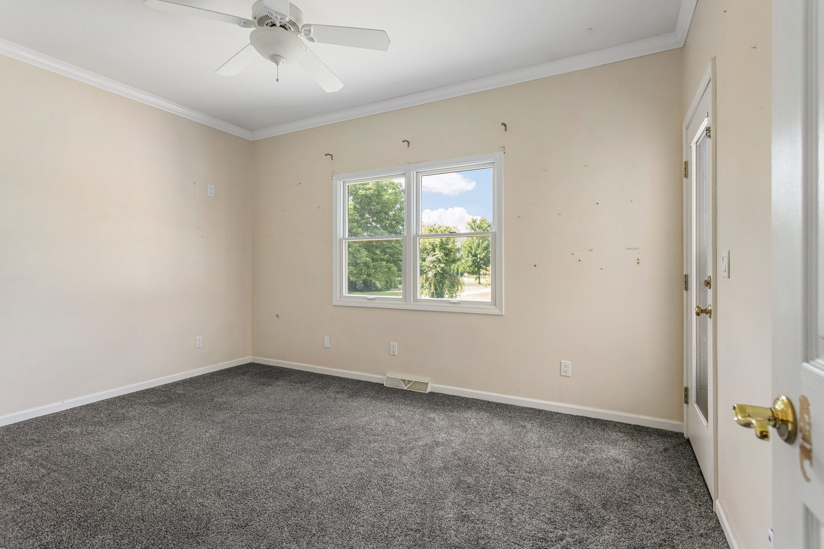1511 River Bluff Court Mahomet, IL 61853 - Photo 26 of 50 an empty room with a window and a fan