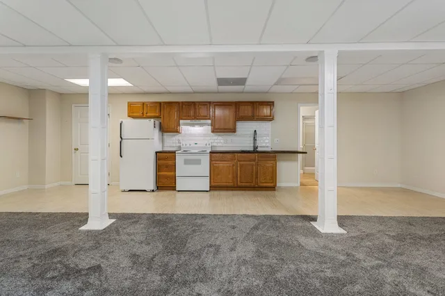 a view of a kitchen with a sink and a refrigerator