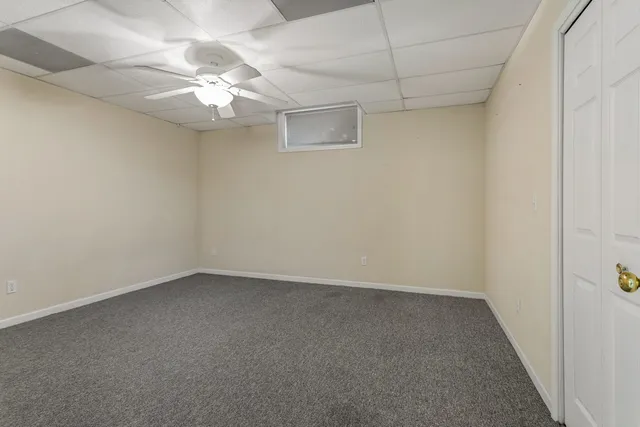an empty room with chandelier fan