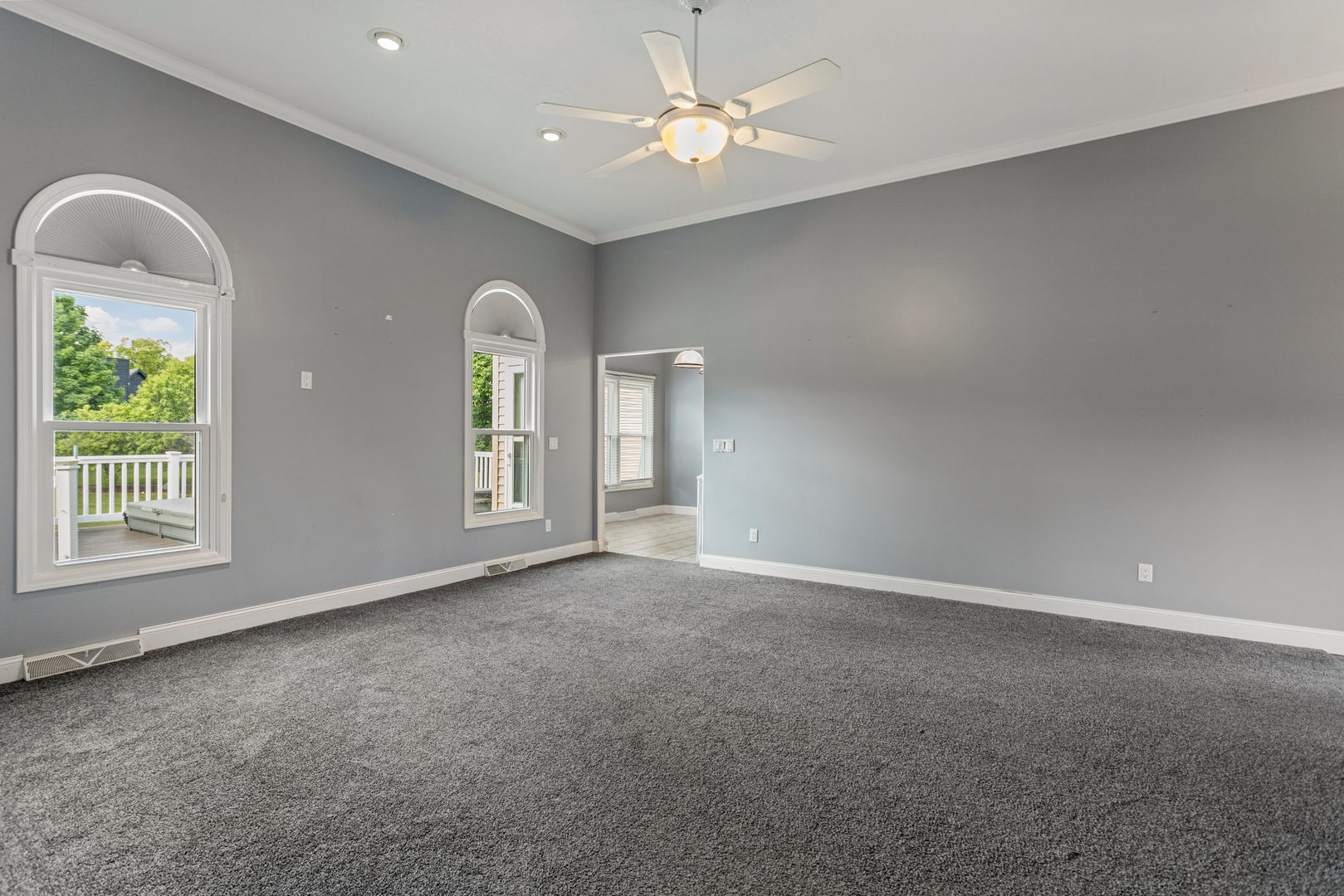 1511 River Bluff Court Mahomet, IL 61853 - Photo 7 of 50 an empty room with windows and ceiling fan