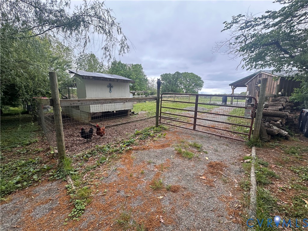 17088 Old Ridge Road Montpelier, VA 23192 - Photo 17 of 18 Gravel pathway leading to a metal farm gate, with