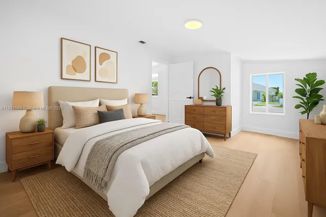 a bedroom with a bed and a large window