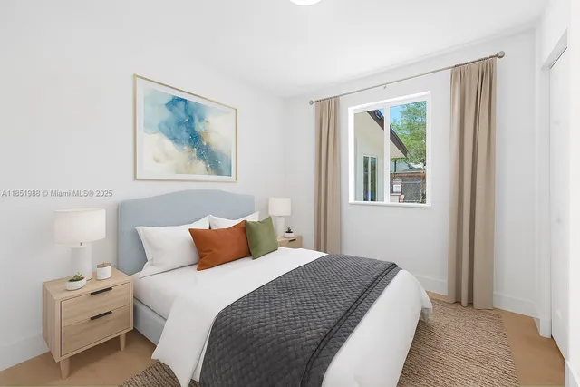 a bedroom with a bed and a painting on the wall