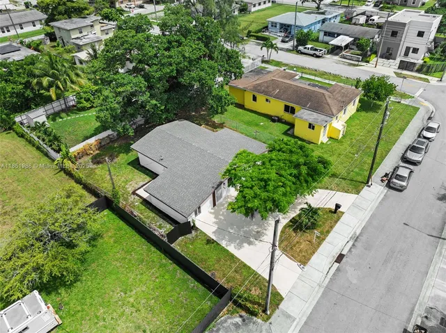 an aerial view of a house with a garden and swimming pool