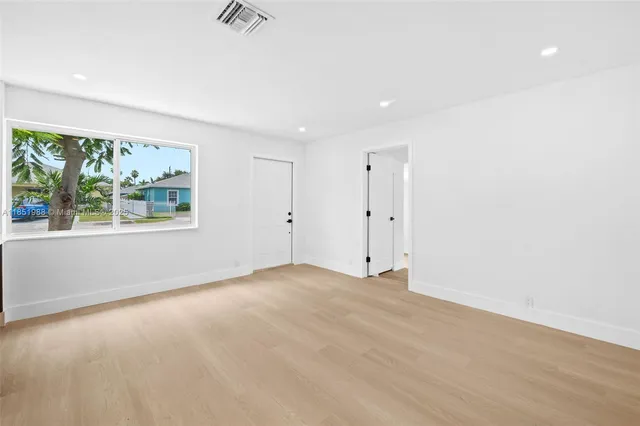 an empty room with large windows