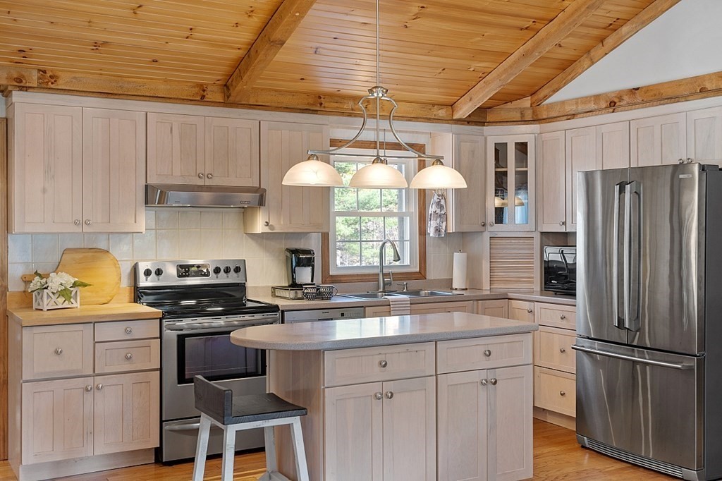 116 Partridgeville Road Templeton, MA 01468 - Photo 11 of 42 a kitchen with kitchen island granite countertop a stove a sink and refrigerator