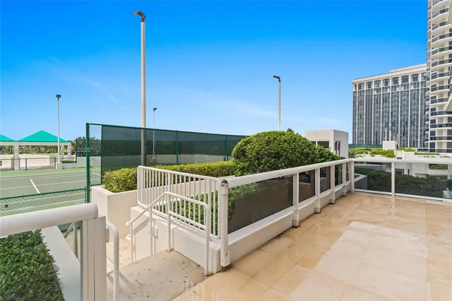 a view of a chair and tables in the balcony