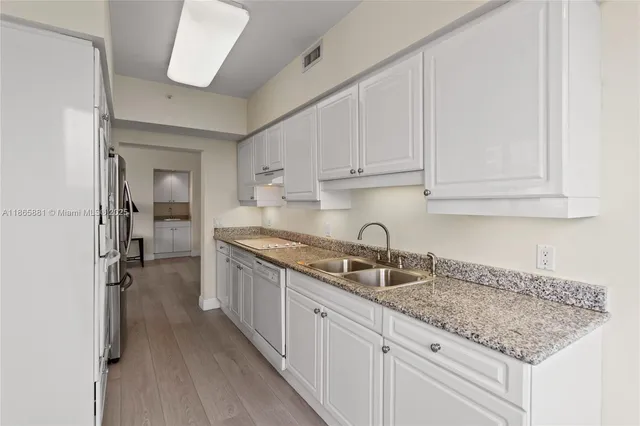 a kitchen with refrigerator cabinets and stove