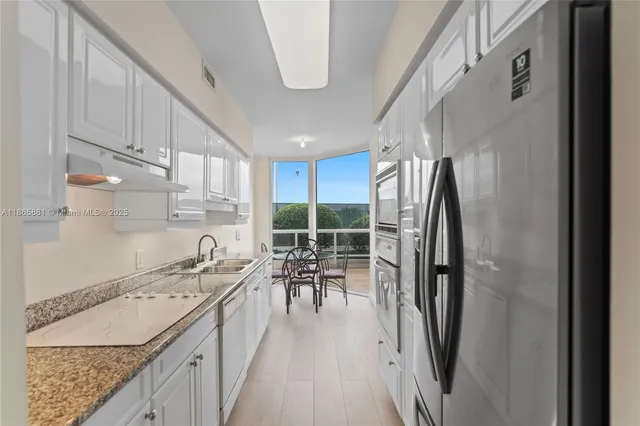a kitchen with a sink a counter top space and appliances