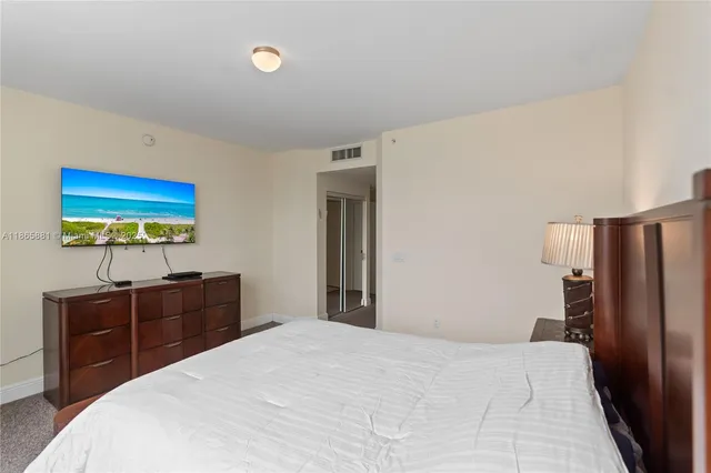 a bathroom with a sink a toilet and a large mirror