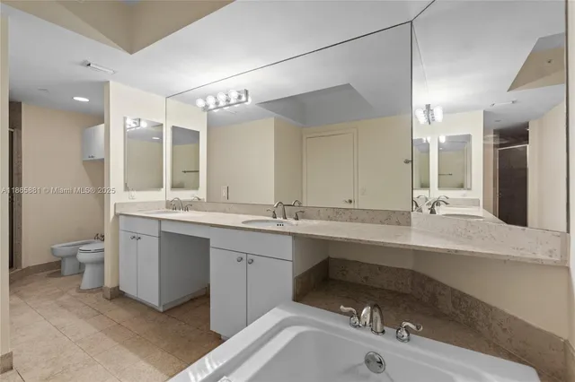 a white toilet sitting next to a shower