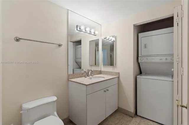 a bathroom with a granite countertop toilet and a shower