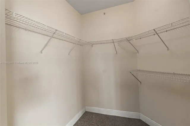 a view of a white house with a sink and porch