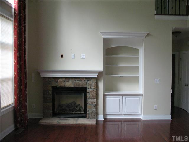 1614 Pattersons Mill Road Durham, NC 27703 - Photo 5 of 16 Family Room with high ceilings, fireplace, bookshelves and hardwood floors. Den/Family/Great Room