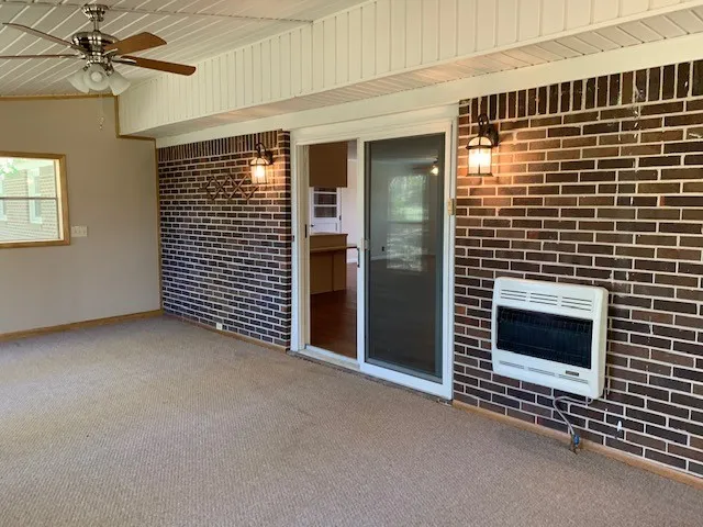 a view of an empty room with a fireplace