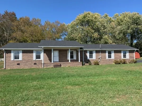 a front view of house with a garden and patio