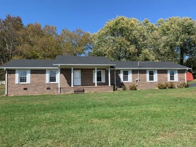 a front view of house with a garden and patio