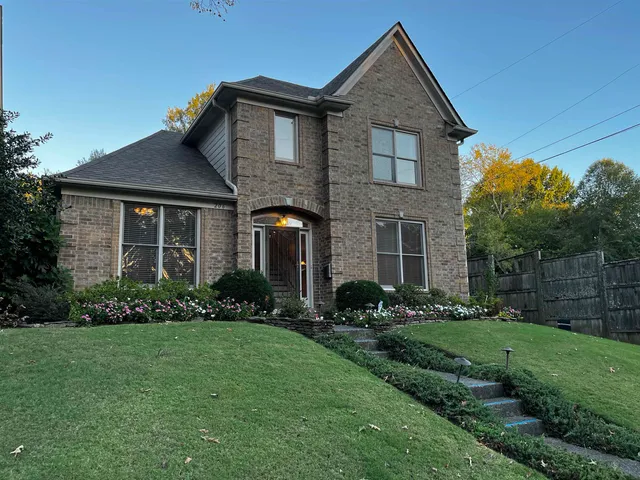 a front view of a house with a yard