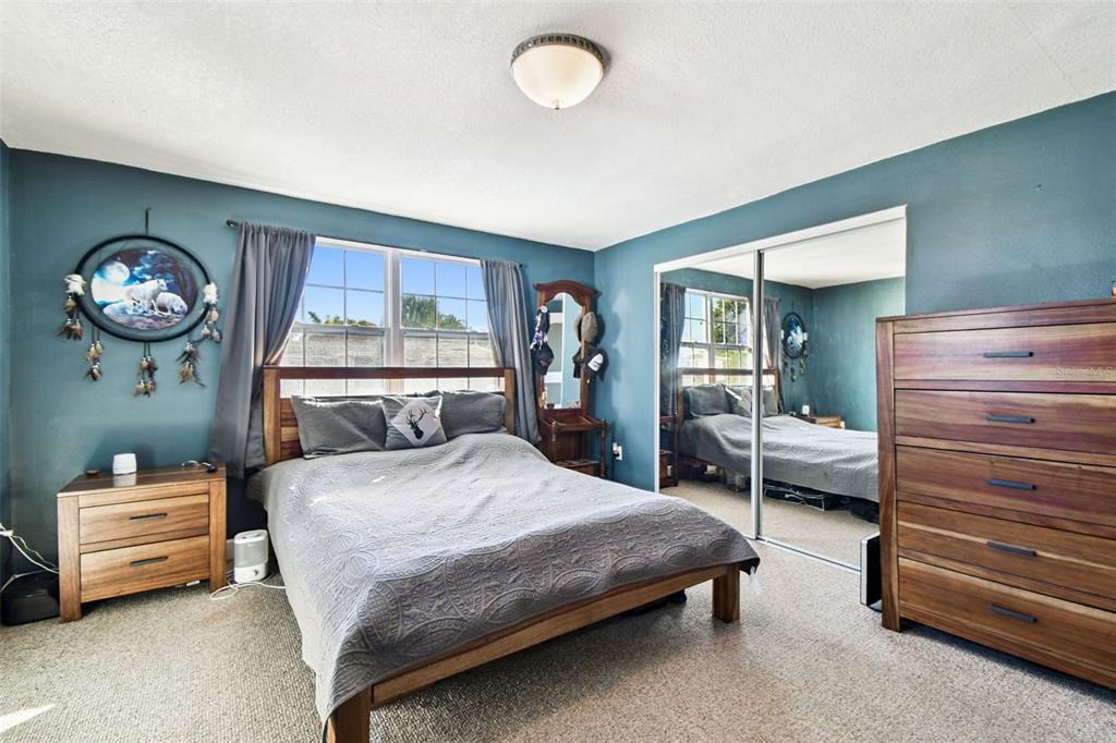 5831 1st Avenue New Port Richey, FL 34652 - Photo 13 of 22 a bedroom with a bed and a dresser