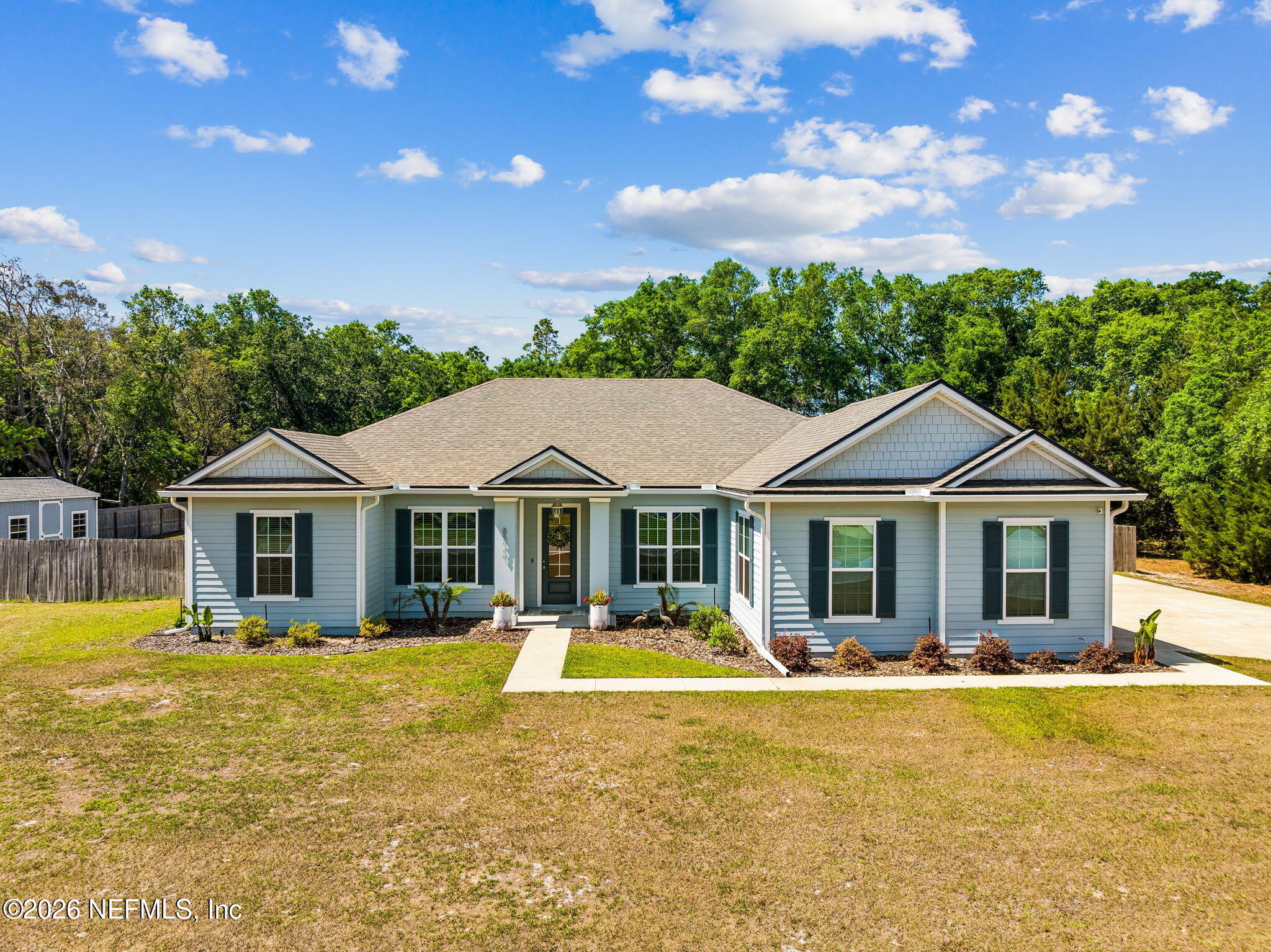 85949 Miner Pines Yulee, FL 32097 - Photo 1 of 55 a front view of house with yard swimming pool and outdoor seating