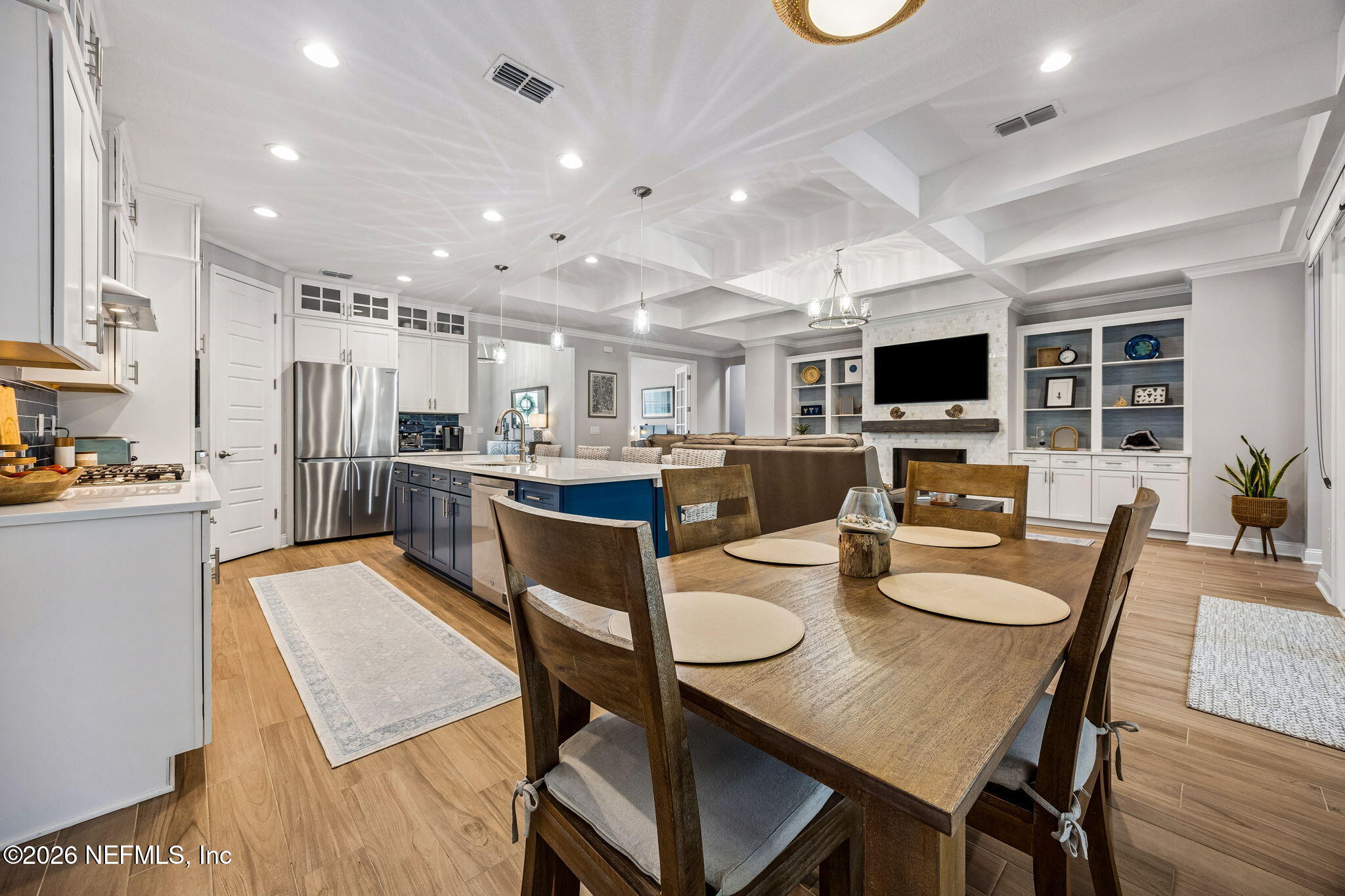 85949 Miner Pines Yulee, FL 32097 - Photo 11 of 55 a open dining room with stainless steel appliances kitchen island granite countertop a dining table chairs and a refrigerator